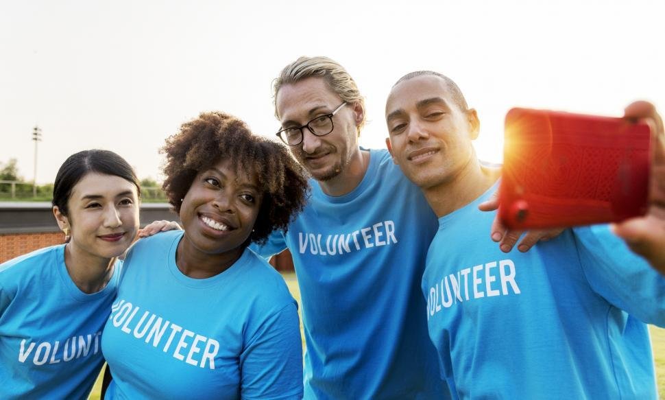 a-group-of-volunteers-taking-a-group-photograph-with-mobile-phone